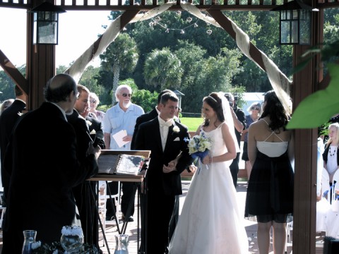 Wedding couple exchanging vows at the wedding ceremony gazebo at Shades of Green