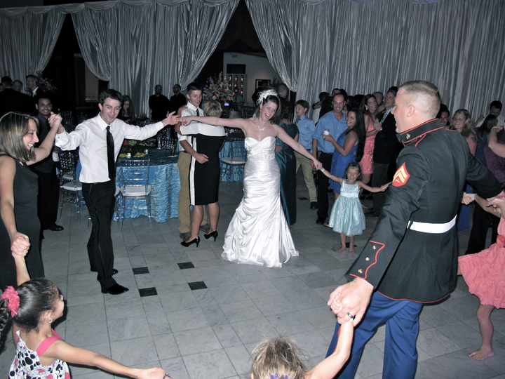 The wedding couple and guests dance at the reception with DJ Chuck Johnson.