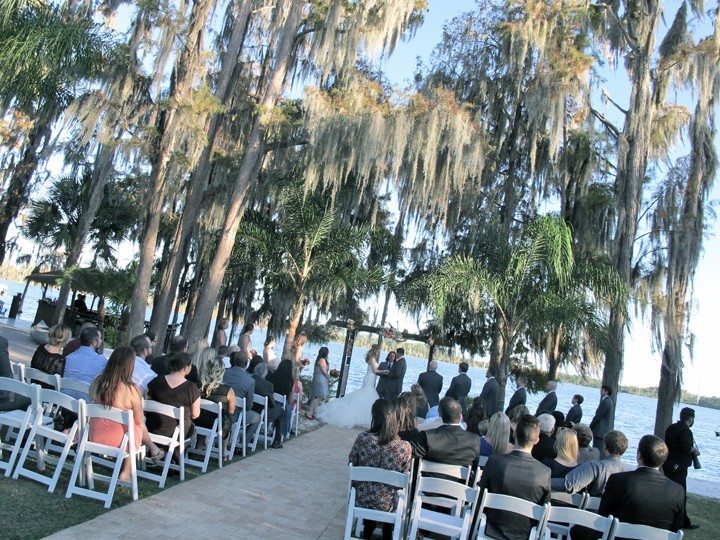 lakeside wedding ceremony location under the palm trees at Paradise Cove Orlando