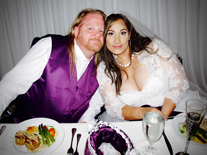 The Happy Couple at the sweetheart table at a Royal Crest Room Wedding Reception