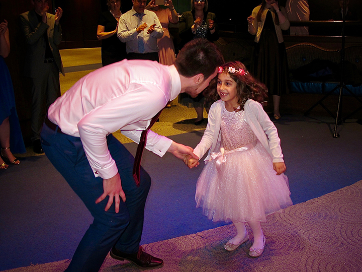 The Groom having fun with the Flower Girl at a wedding at Walt Disney World