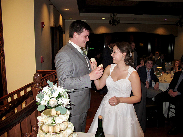 The wedding couple cuts the cake at the Tavares Pavilion on the Lake.
