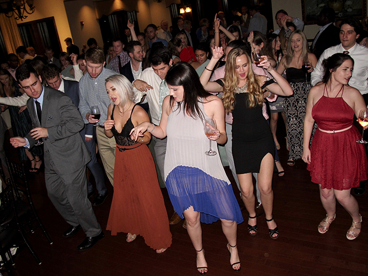 Wedding guests dancing as DJ Chuck Johnson plays tunes at the reception.