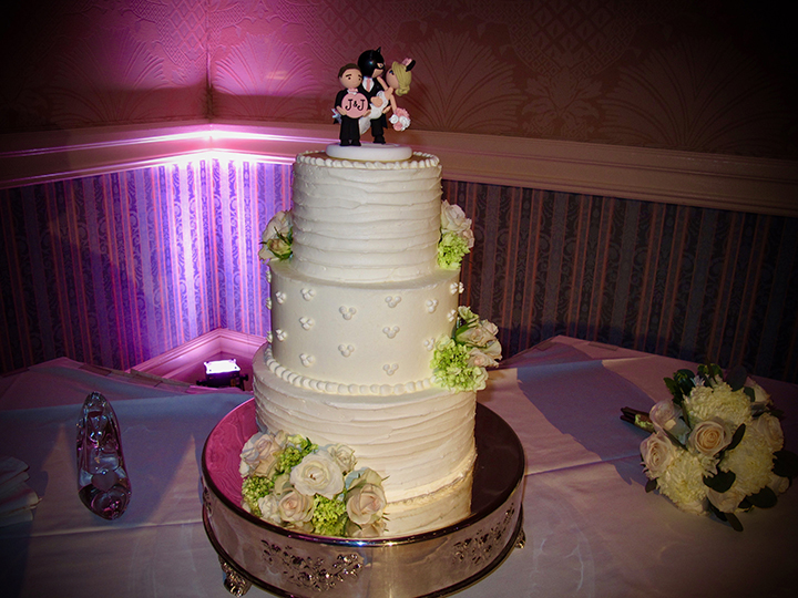 A Batman cake topper adorns the cake at this Walt Disney World Wedding Reception.