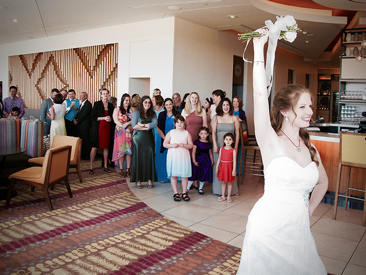 The bride is tossing the bouquet; Orlando Wedding DJ Chuck can help with all of the events at your reception.