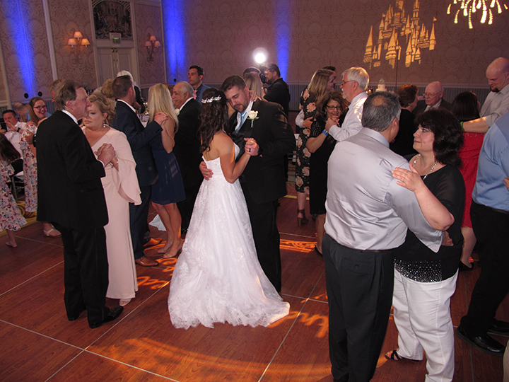 The bride and groom are dancing with family to music from Orlando Wedding DJ Chuck Johnson.