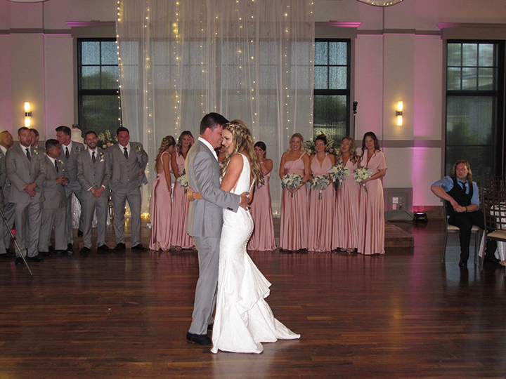 The wedding couple share their First Dance as husband and wife on the dance floor.
