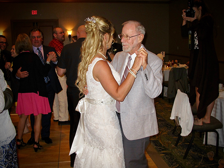 The Bride dances with a guest at her wedding reception.