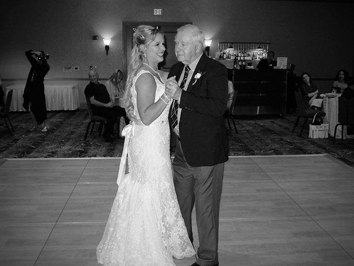 The Bride dances with her dad in a special Family Dedication Dance at the reception.