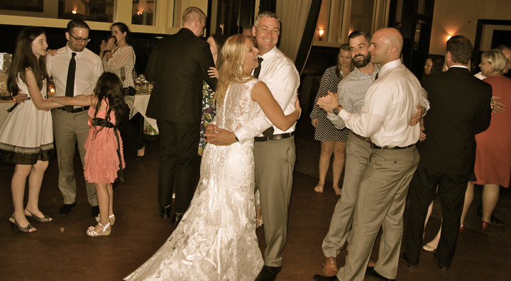 The bride and groom dance with their guests at the wedding reception with music provide by Orlando DJ Chuck Johnson.