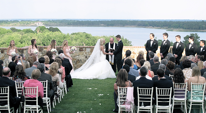 A wedding couple are exchanging their vows during their wedding ceremony on the Grande Lawn.