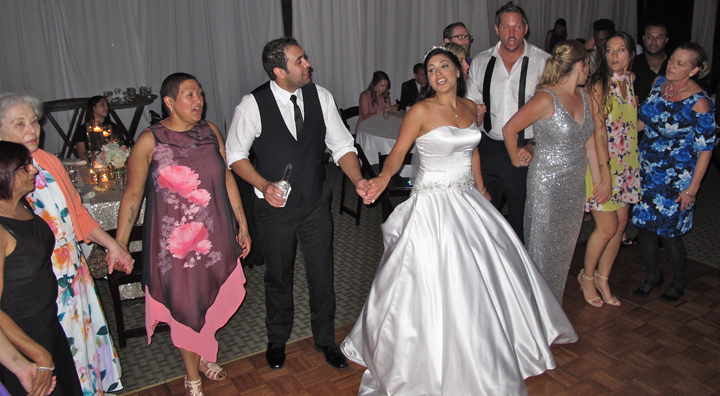 Having fun the at the wedding reception with a bride and groom and their guests at the Mission Inn Resort.