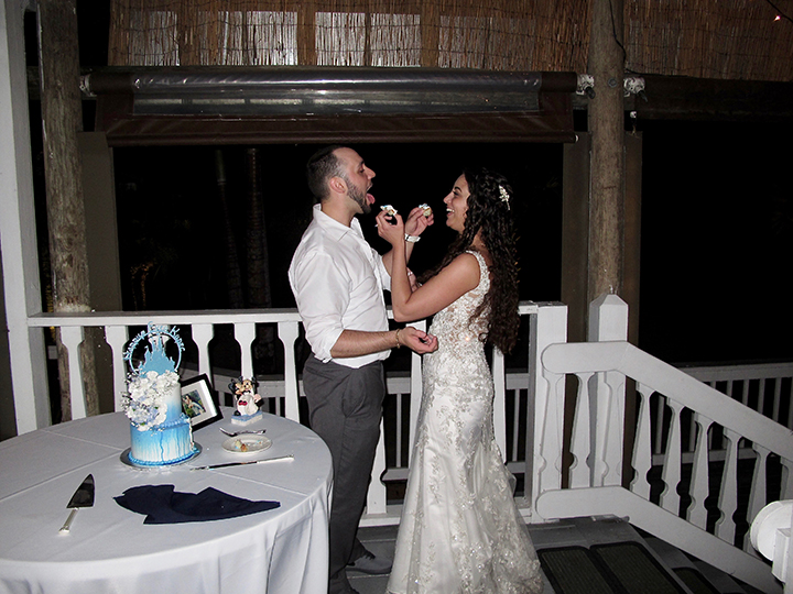 Orlando Wedding DJ Chuck Johnson helps this couple cutting their wedding cake.