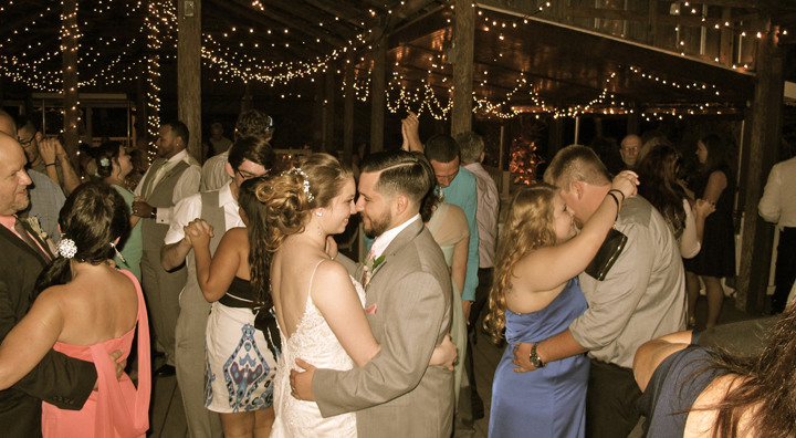 A bride and groom dance the night away with family and friends at Orlando's Paradise Cove Wedding venue.