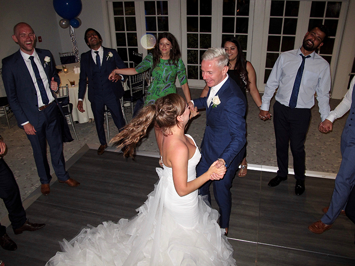The bride and groom are dancing with their guests at the reception with Orlando Wedding DJ Chuck Johnson.