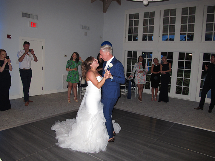 The bride and groom share their first dance at the wedding reception with Orlando DJ Chuck Johnson.