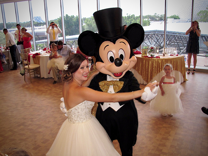 A bride dances with Mickey Mouse at her GM lounge wedding in Epcot with Orlando DJ Chuck Johnson.