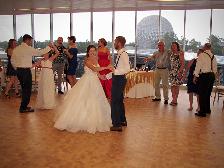 Wedding guests enjoy the view of Spaceship Earth from the GM Lounge at Epcot.