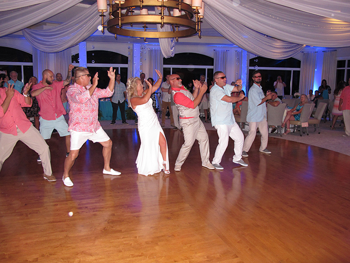 The bride and groom get a little crazy on the dance floor with Orlando DJ Chuck Johnson at the Hammock Dunes Club.