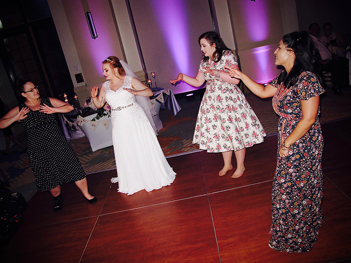 The bride on the dance floor with her family and Orlando Wedding DJ Chuck Johnson.