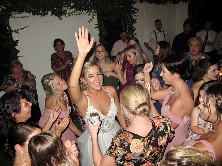 The bride celebrates with family and friends at her wedding at the Acre Orlando with DJ Chuck Johnson