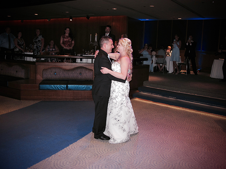 A bride and groom share their First Dance together at a Walt Disney World Wedding with Orlando DJ Chuck Johnson.
