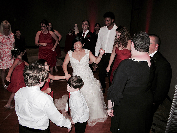 The bride is on the dance floor celebrating her reception with Orlando Wedding DJ Chuck at Shades of Green