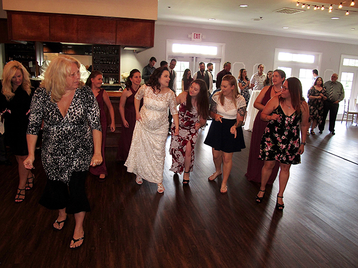 The Bride and her friends gather on the dance floor for her wedding at the Tuscawilla Country Club.