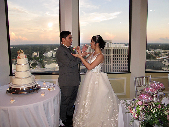 The couple cut the cake at their Orlando Citrus Club wedding reception.