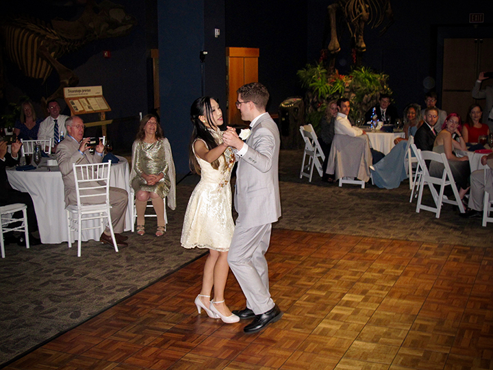 The bride and groom share the first dance at their wedding reception at the Orlando Science Center.