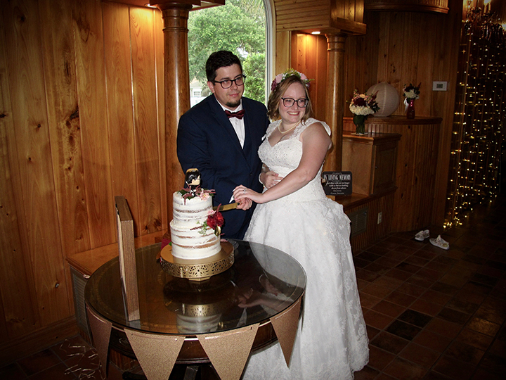 The wedding couple cut their cake at their reception at the Estate on the Halifax.