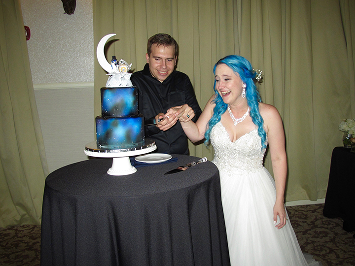 The wedding couple cut the cake at the Lake Mary Events Center.