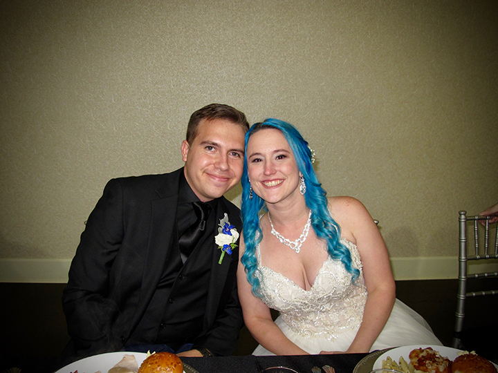 The bride and groom seated for their meal at the Lake Mary Events Center.
