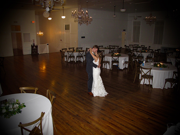 The wedding couple share a private moment on the dance floor of Venue 1902 in Sanford.