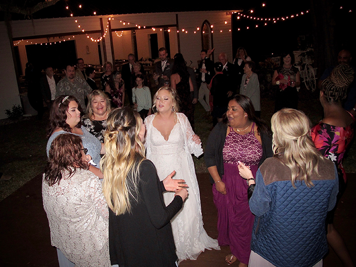 The bride dances with her guests on the dance floor at the Cattleya Chapel Weddings Venue in Vero Beach.