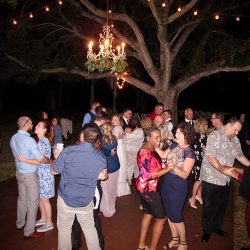 Guests are on the dance floor under the stars at the Cattleya Chapel Weddings Venue.