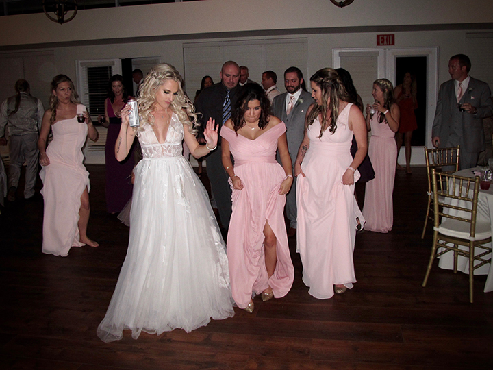 The bride and her friends are having fun on the dance floor at the Florida Federation of Garden Clubs.