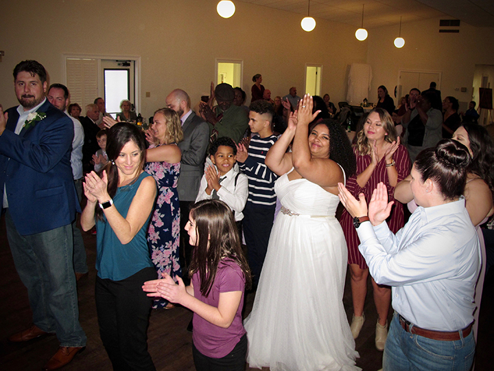 Friends and family of the wedding couple having fun on the dance floor at Mead Gardens in Winter Park.