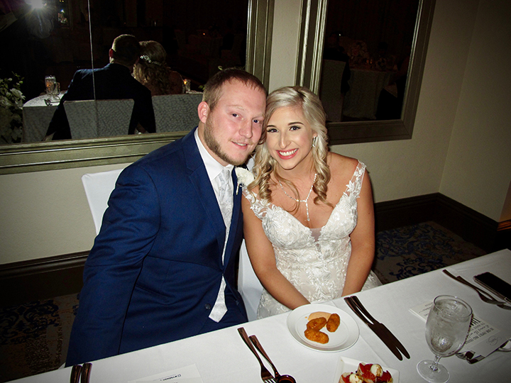 The bride and groom at the their sweetheart table at the Wyndham Grand Resort Bonnet Creek.