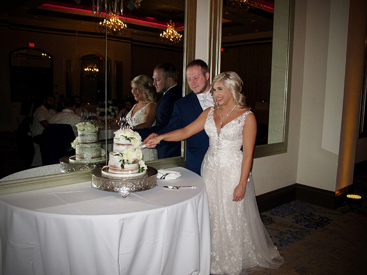 This Wyndham Grand Resort Bonnet Creek Wedding has the couple cutting the cake.