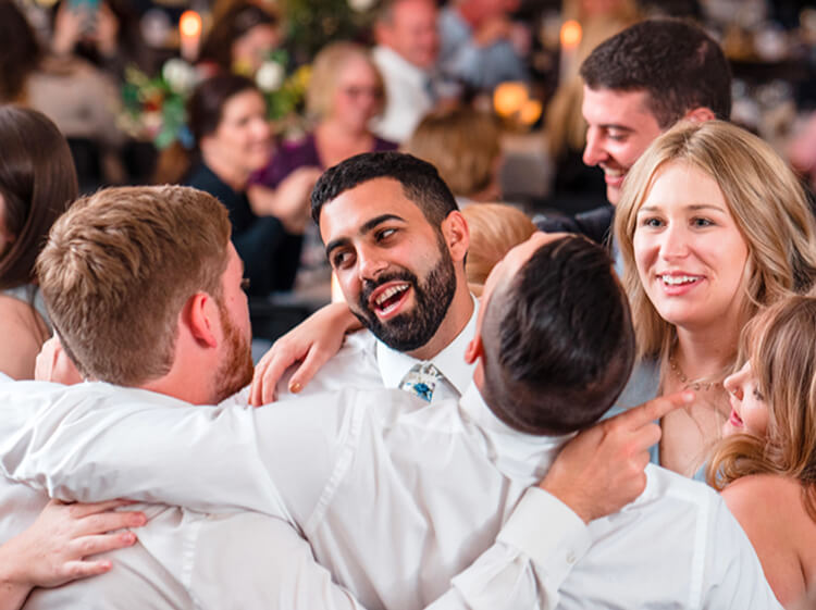 a group of wedding guests having fun on the dance floor at the Azalea Lodge at Mead Garden Wedding Venue