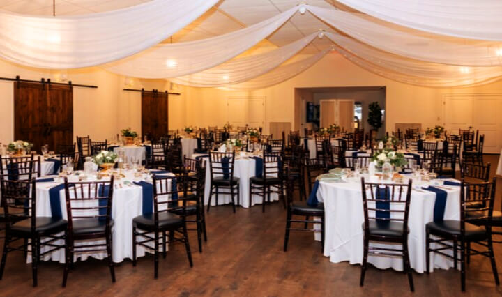 Interior view of a wedding reception setup at the Azalea Lodge at Mead Garden Wedding Venue