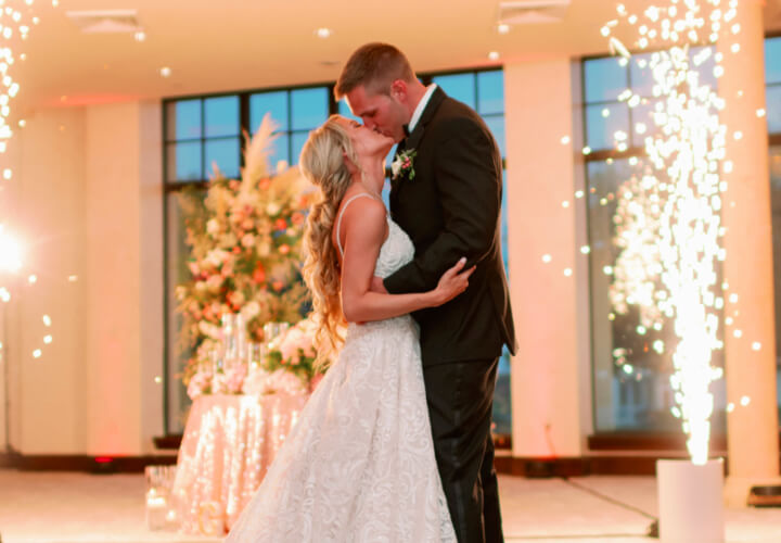 a bride and groom dancing their first dance at their wedding reception at the bella collina wedding venue in montverde, florida